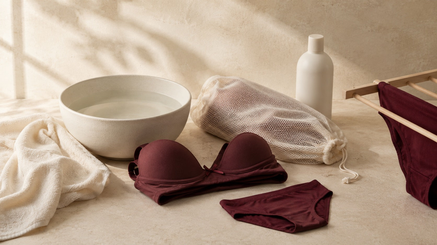 Bra, underwear, mesh laundry bag and mild washing accessories arranged for gentle intimate-care washing.